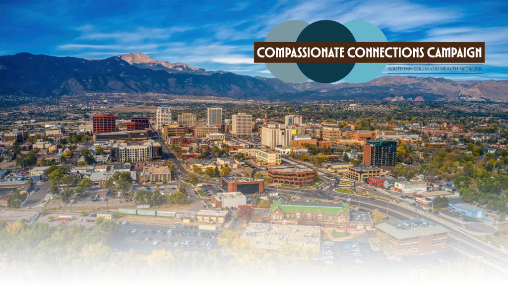 An image of Colorado Springs from the east looking west over downtown with the Compassionate Care Campaign logo in the top right corner.